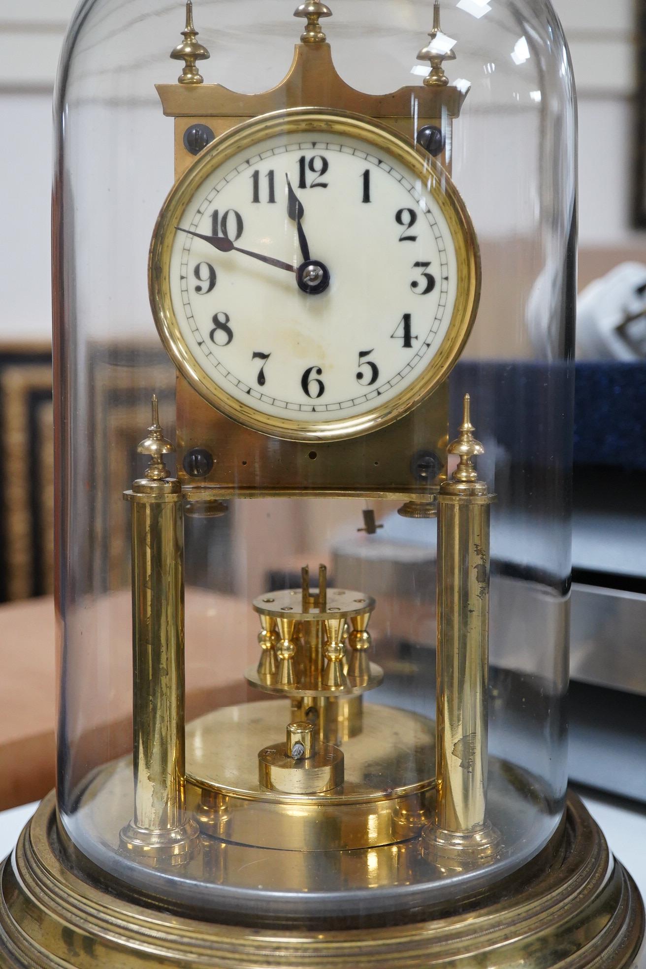 A late 19th century 400 day brass Anniversary clock, under glass dome, 29cm high